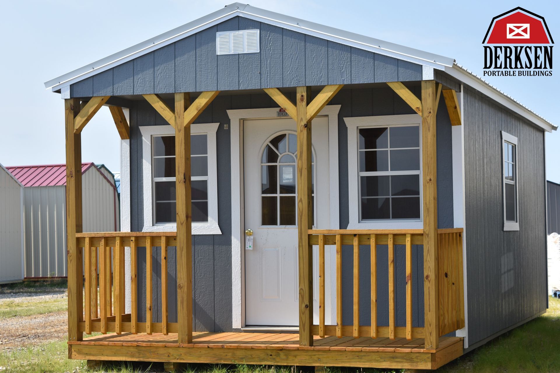A small house with a porch and a sign that says ' derk ' on it