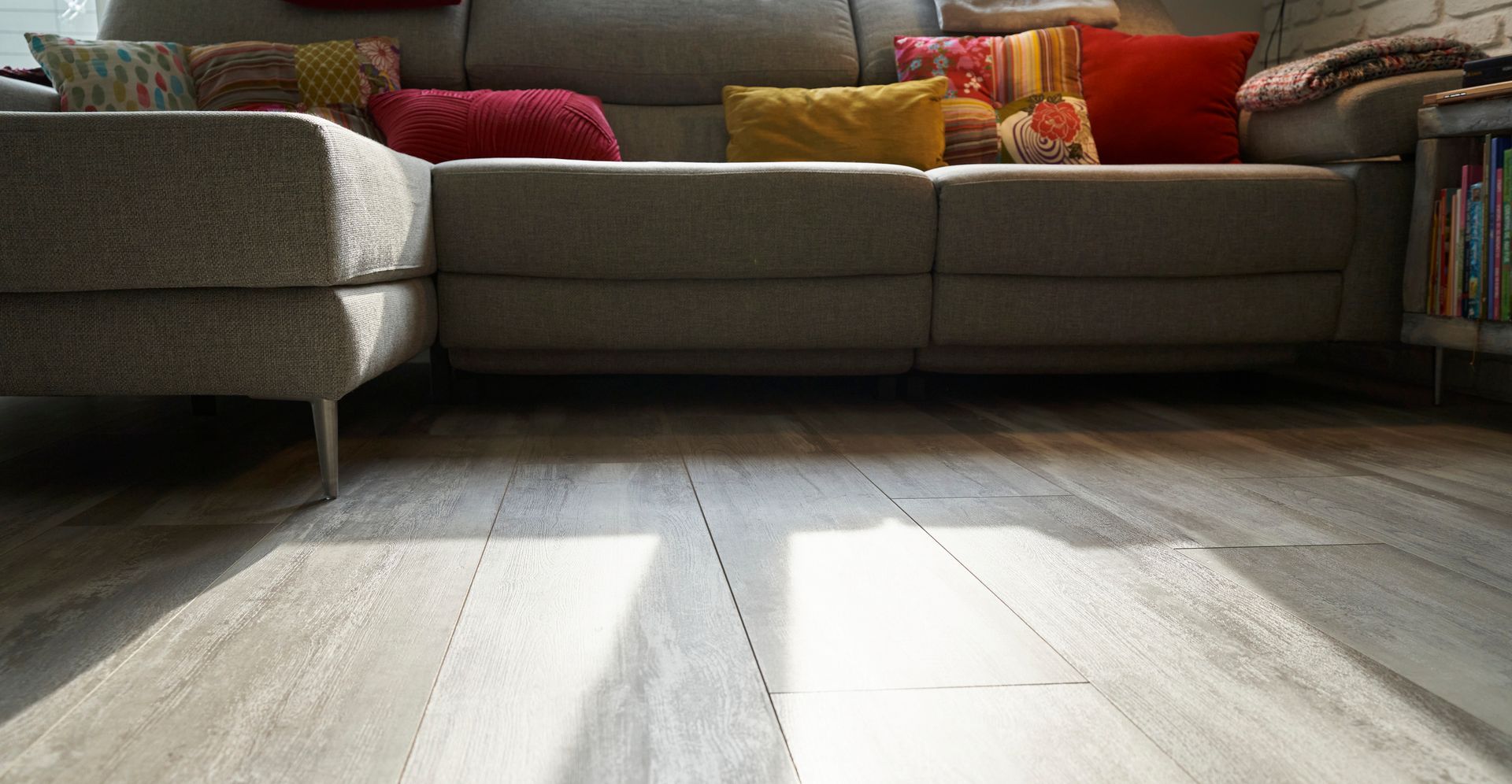 A living room with tile floors and a sliding glass door leading to a deck.
