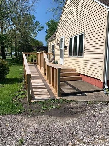 A house with a wooden ramp leading to the front door.