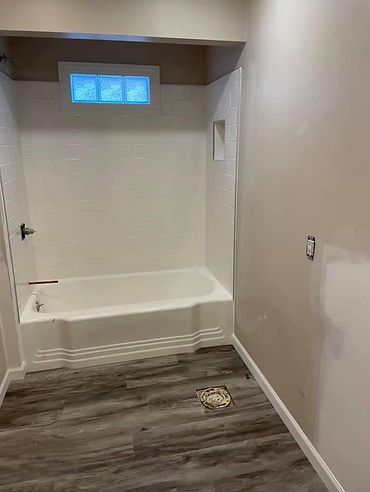 A bathroom with a bathtub and a shower.