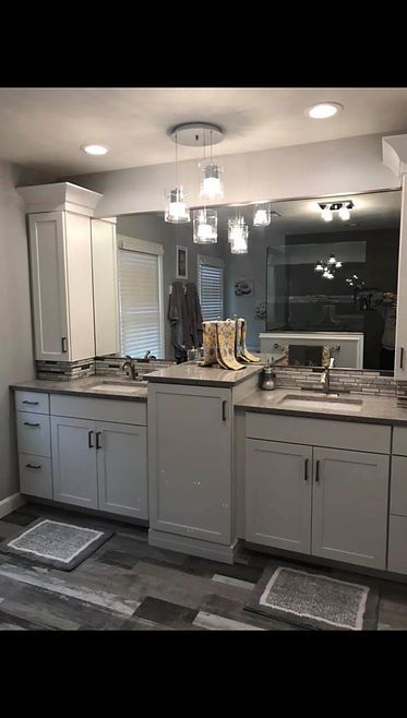 A bathroom with two sinks and a large mirror.