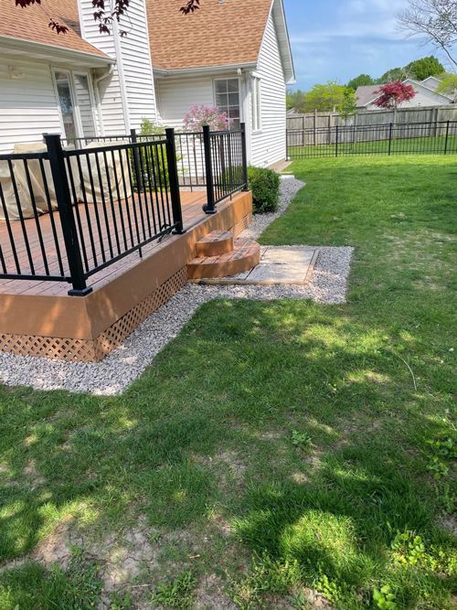 A house with a deck and stairs in front of it.