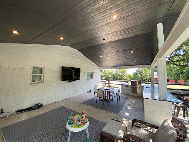 A covered patio installation in McKinney, TX by Waterfalls Construction