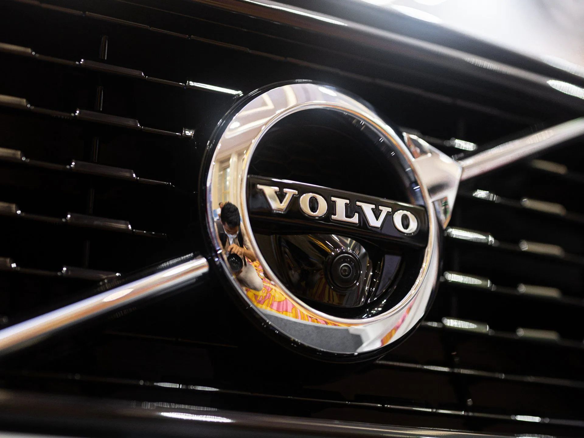 Close-up of a Volvo car grille with chrome logo on a black front