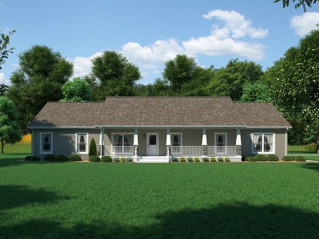 Single-story gray house with white trim and a large green lawn under a blue sky with trees