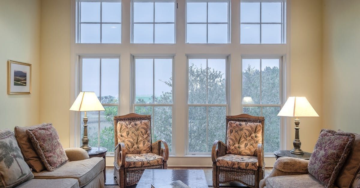 A living room with a lot of windows and furniture