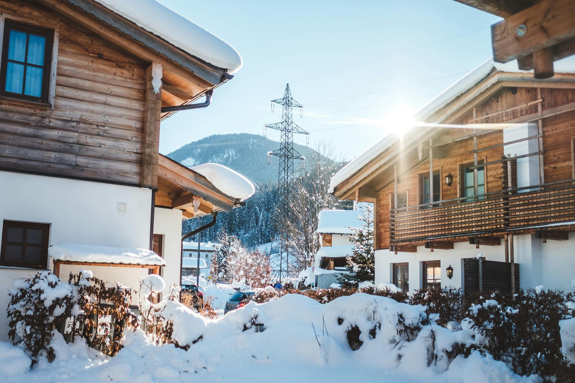 A snowy village with a lot of snow on the ground and houses covered in snow.