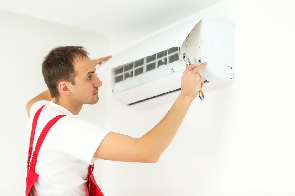 Technician Repairing Split Type Air-conditioner  — North West Heating, Cooling and Refrigeration in Taminda, NSW