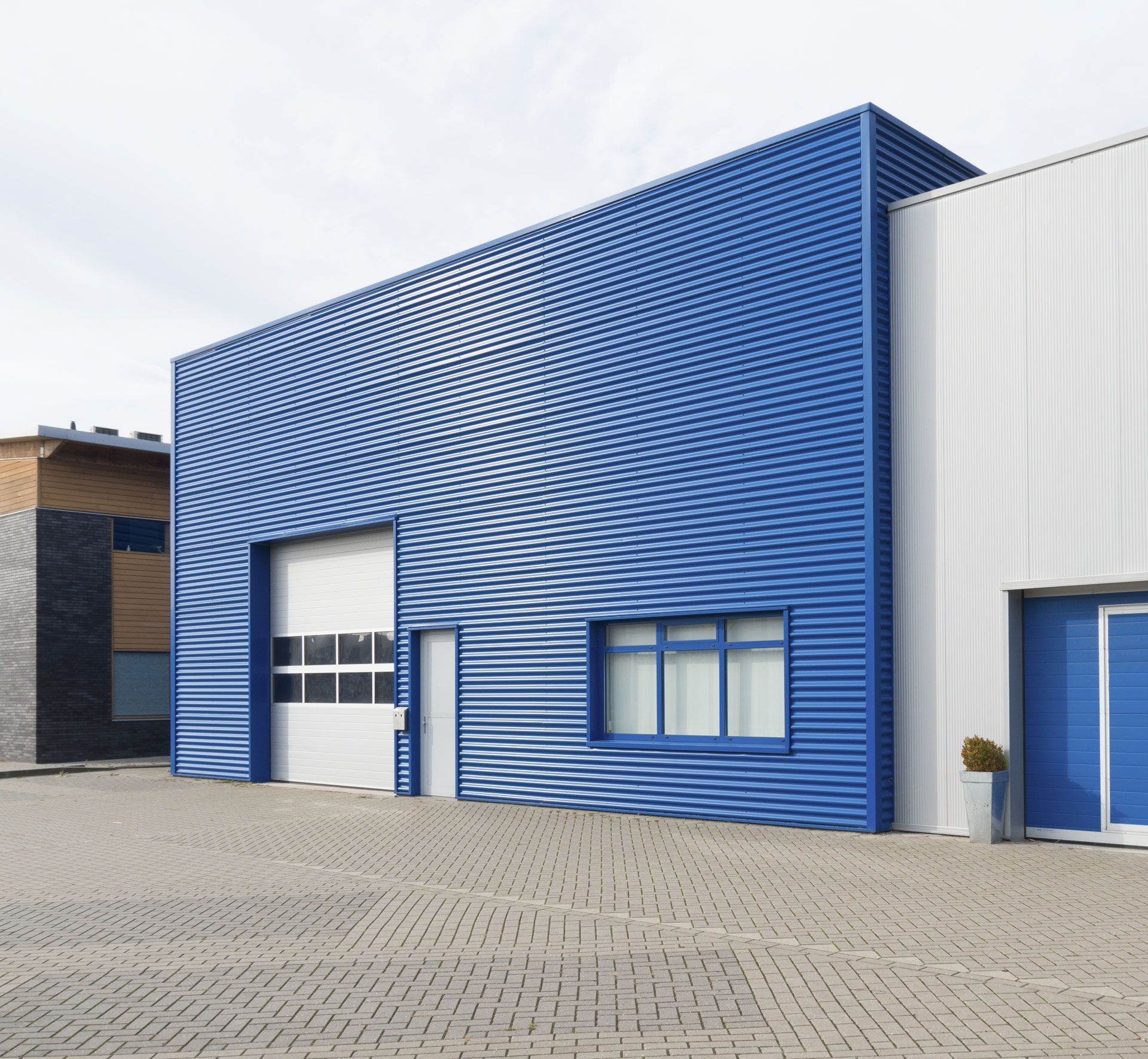 A blue and white building with a white garage door