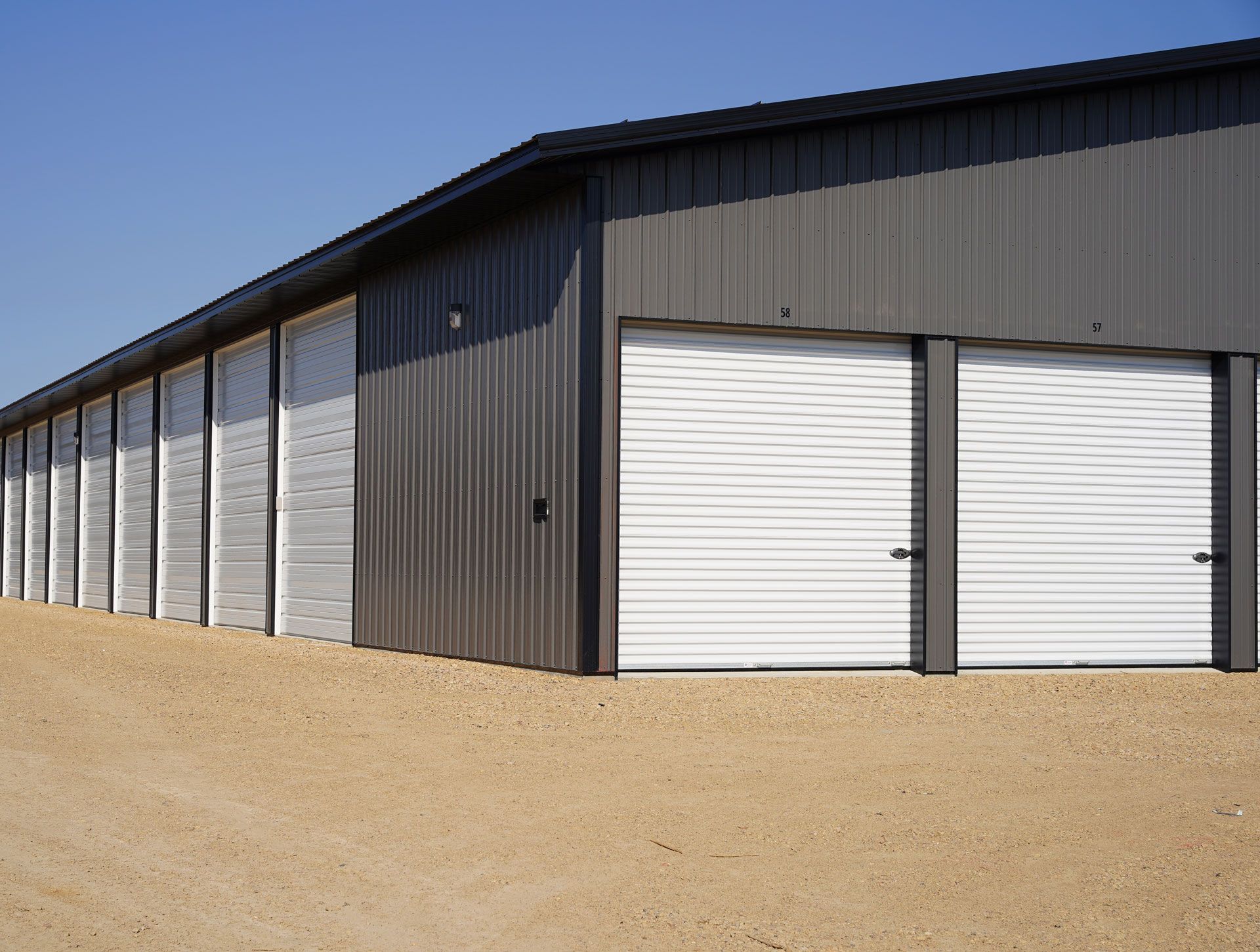 A row of storage units with white garage doors