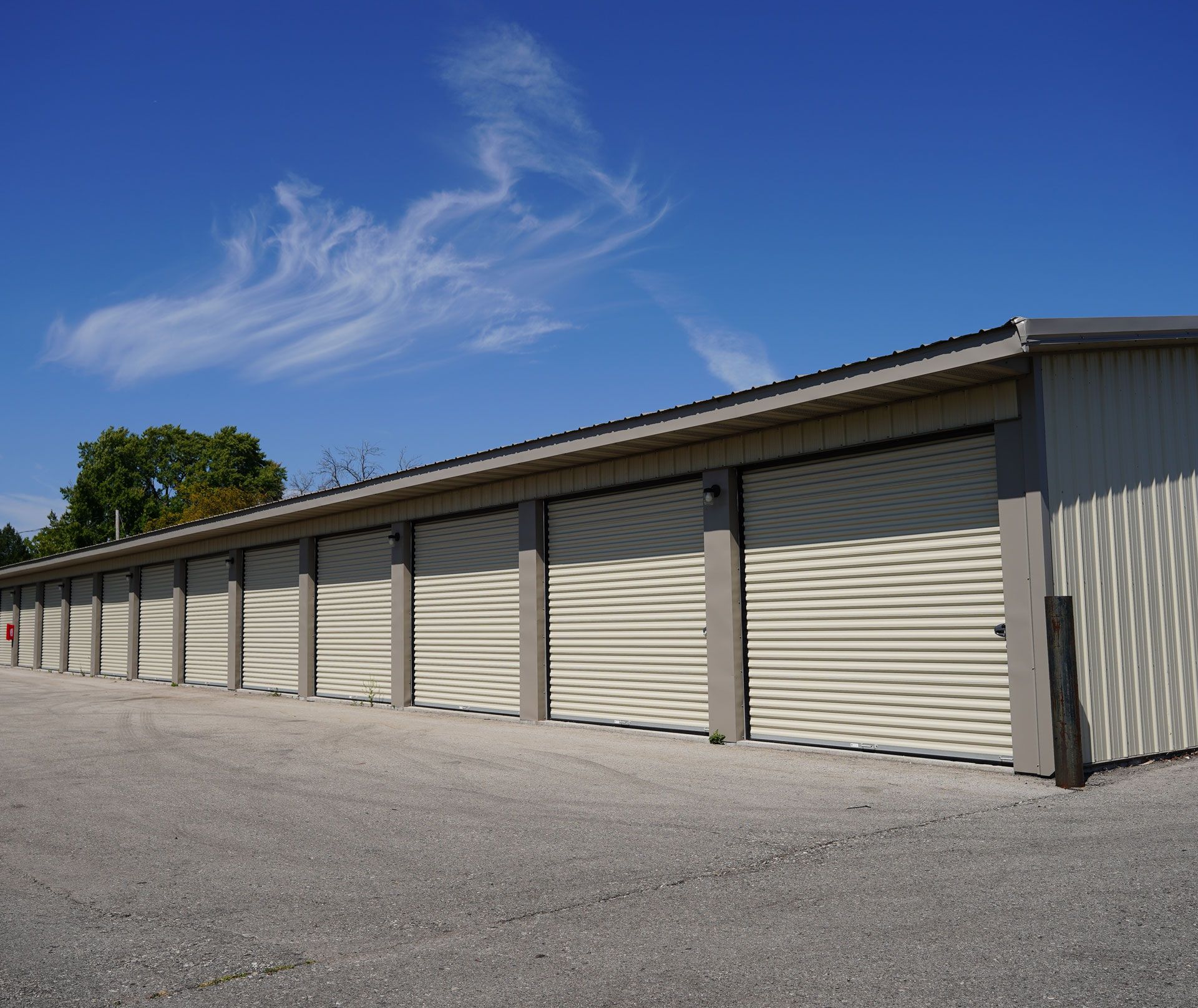 A row of garage doors with a blue sky in the background