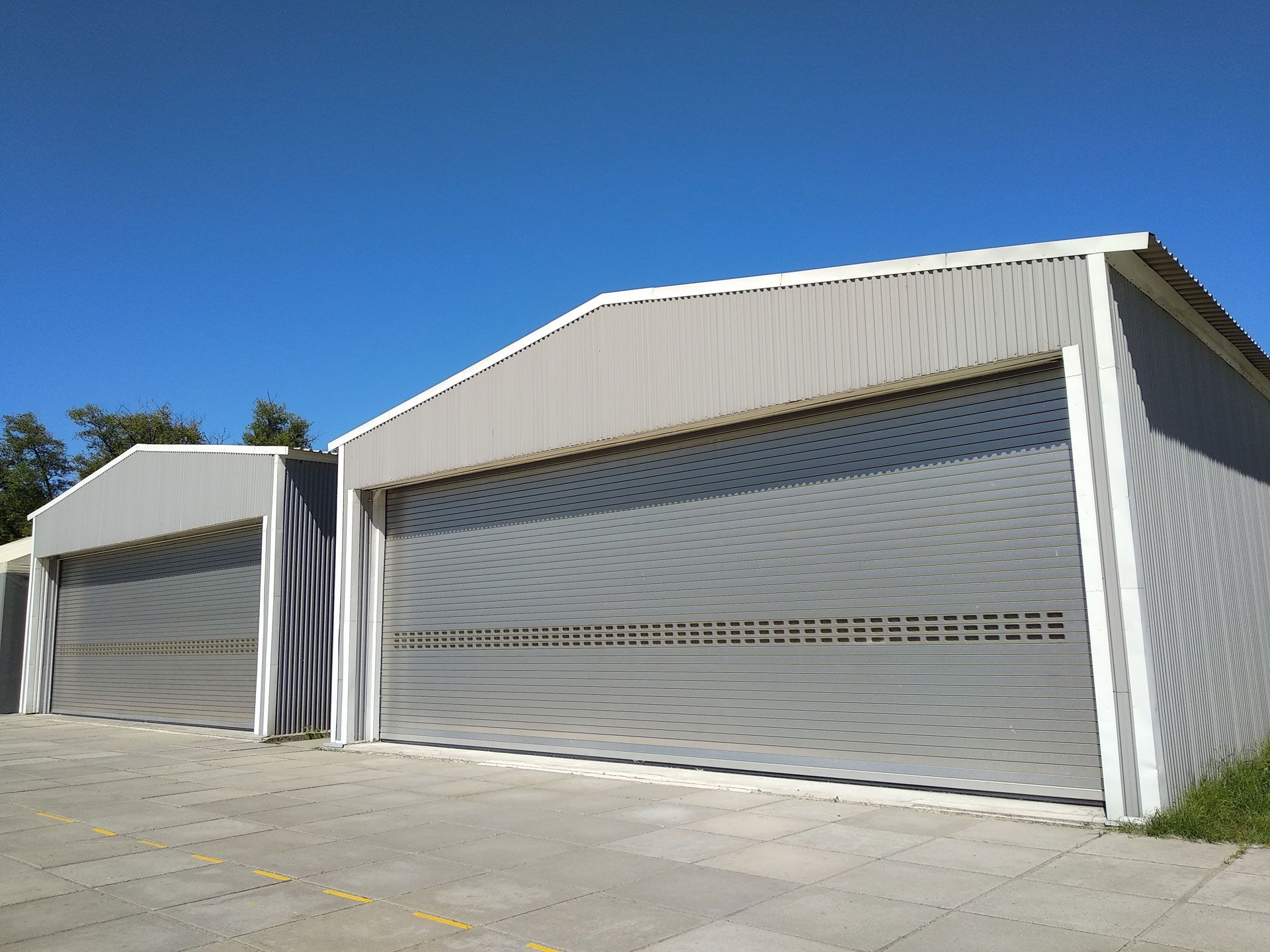A row of garage doors with a blue sky in the background