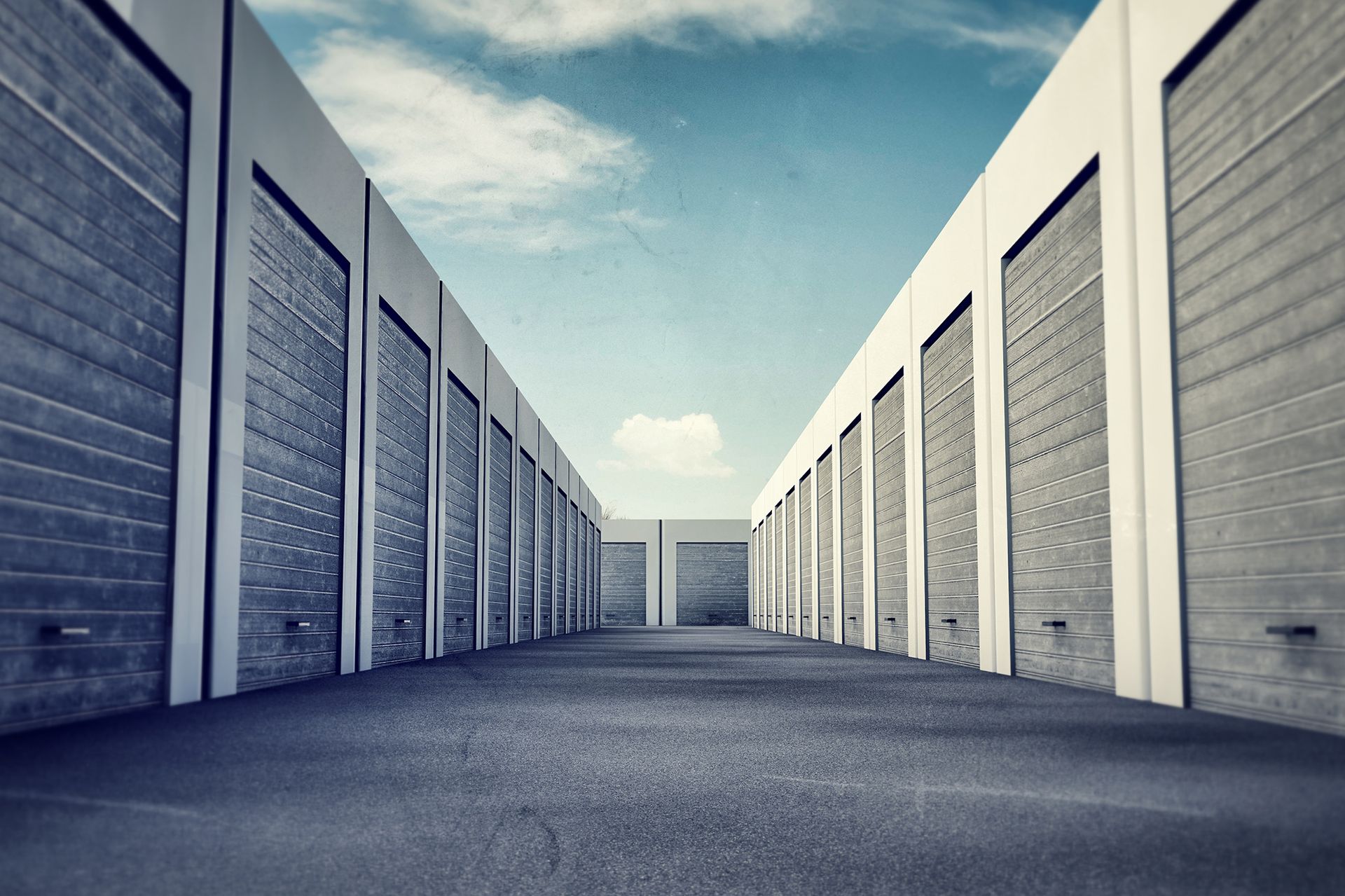 A row of storage units with a blue sky in the background.