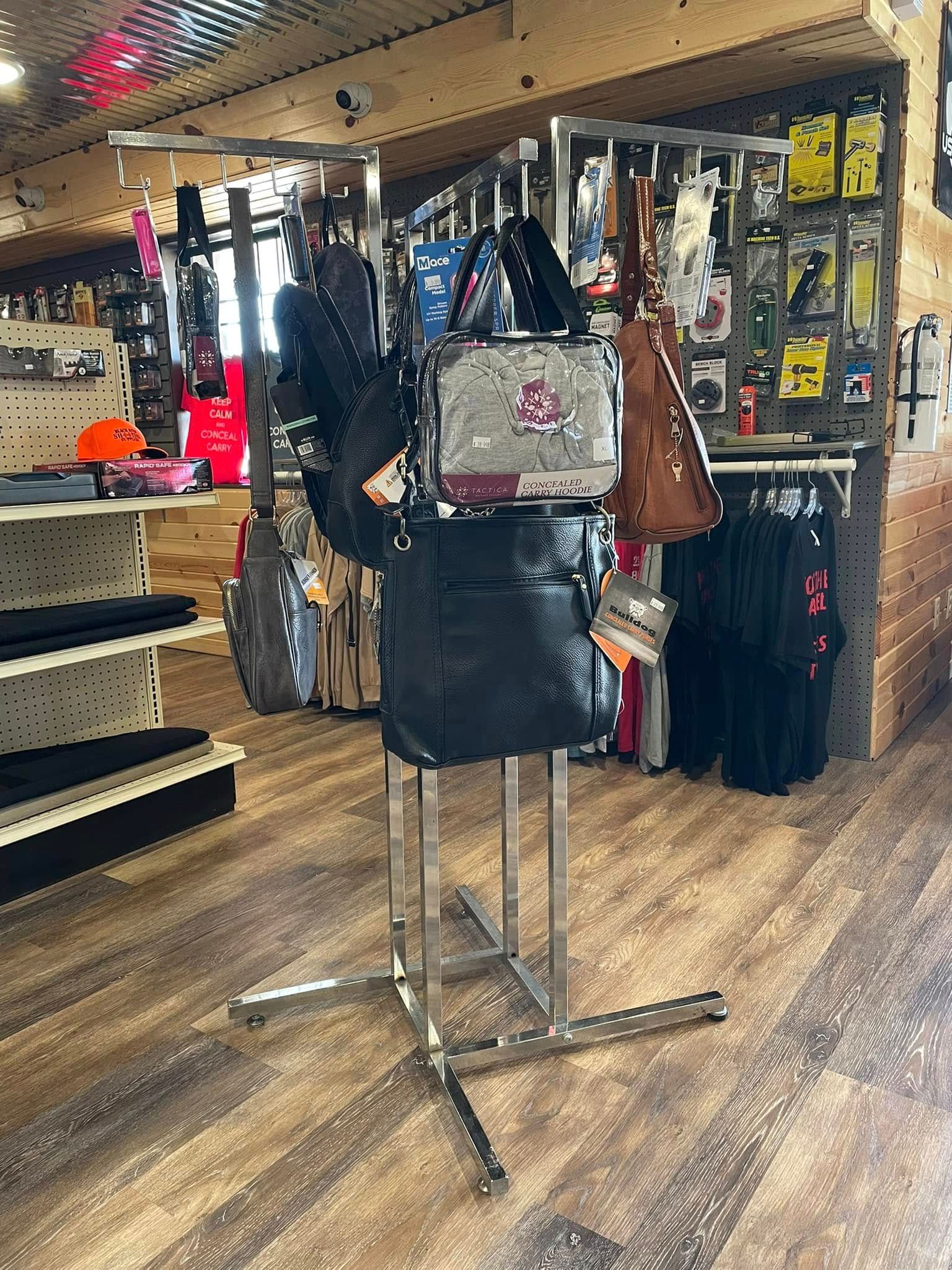 A display of handbags and backpacks in a store.
