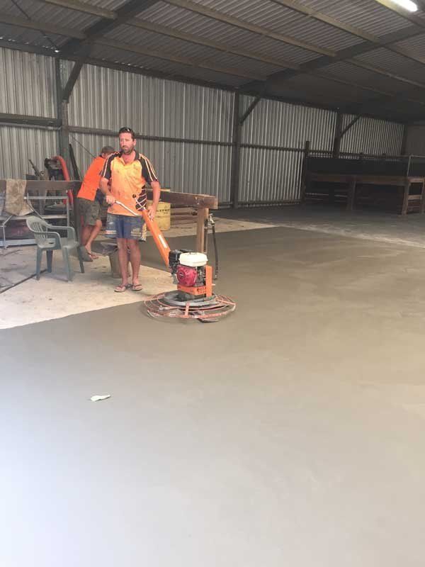 worker smoothing concrete