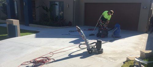 worker resurfacing concrete