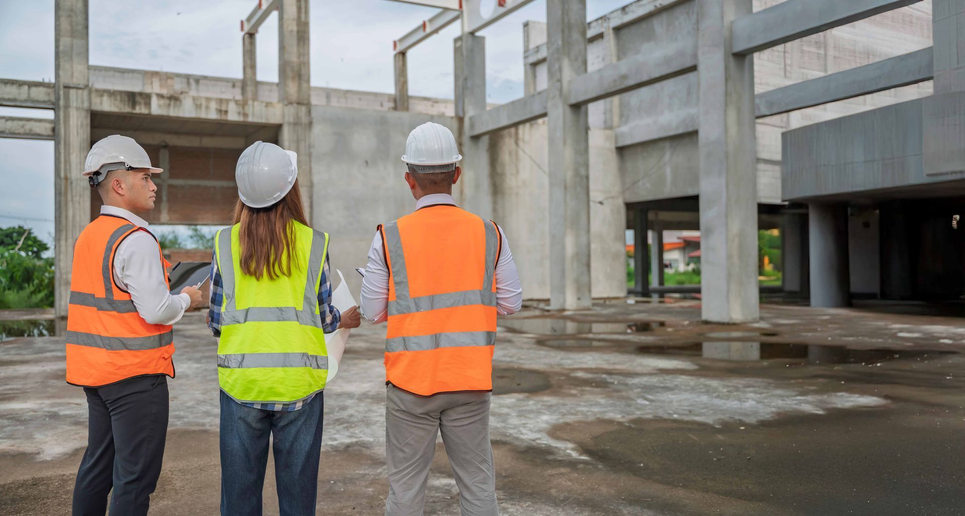 A team of structural engineers reviews construction safety and site progress.