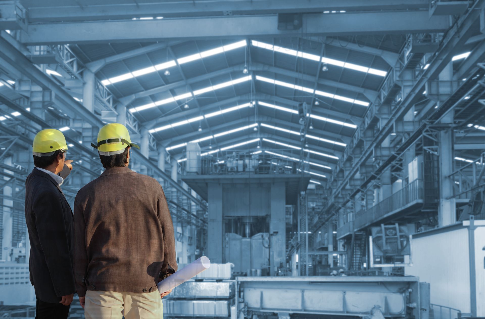 Commercial structural engineering professionals reviewing blueprints. Commercial structural engineering professionals reviewing blueprints.