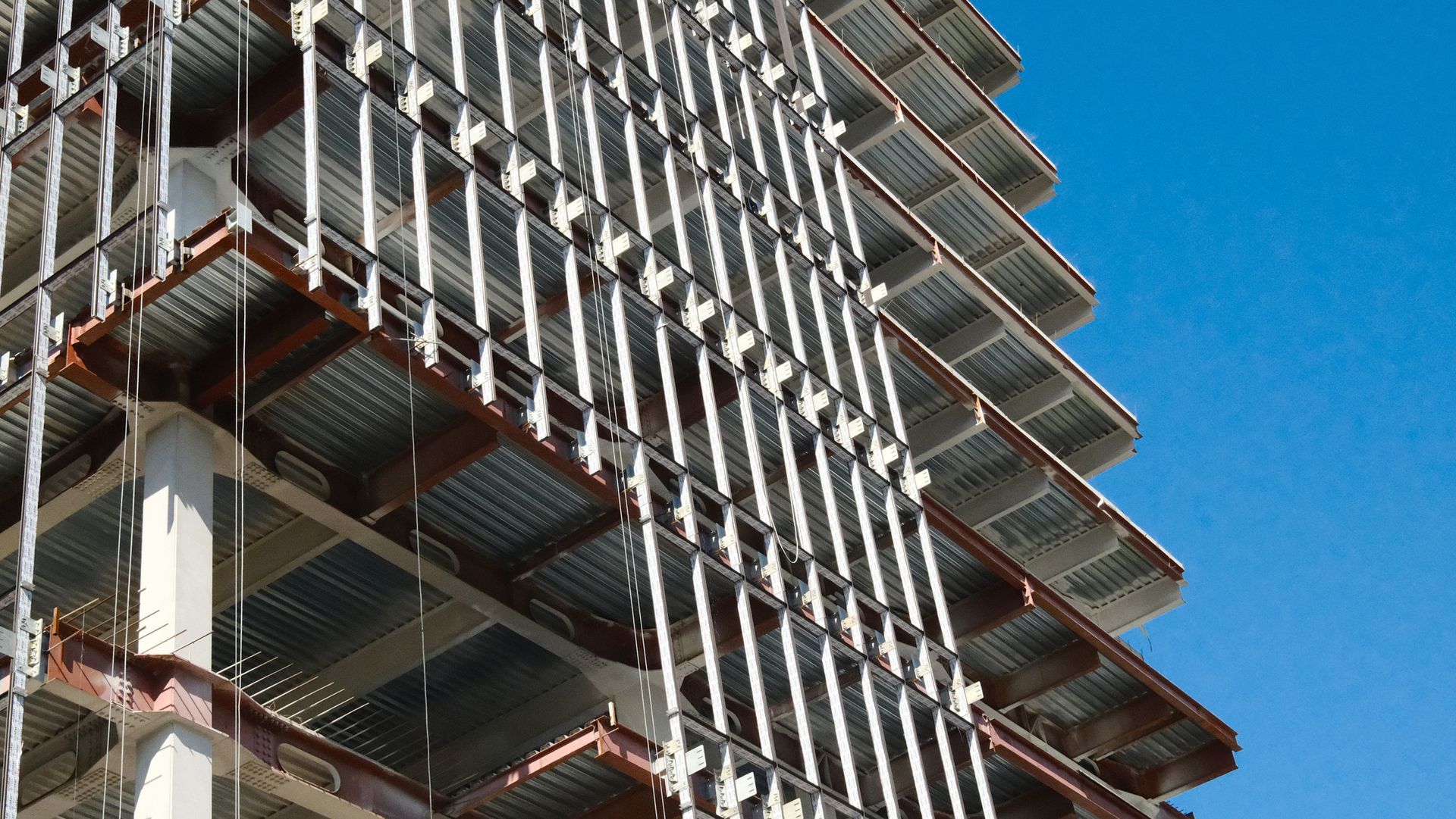 Steel framework of modern high-rise building showing residential structural engineering design.