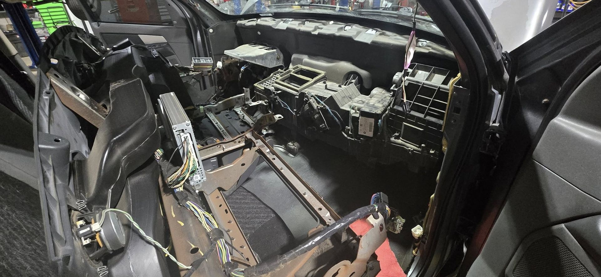 Car interior with the dashboard and components disassembled.