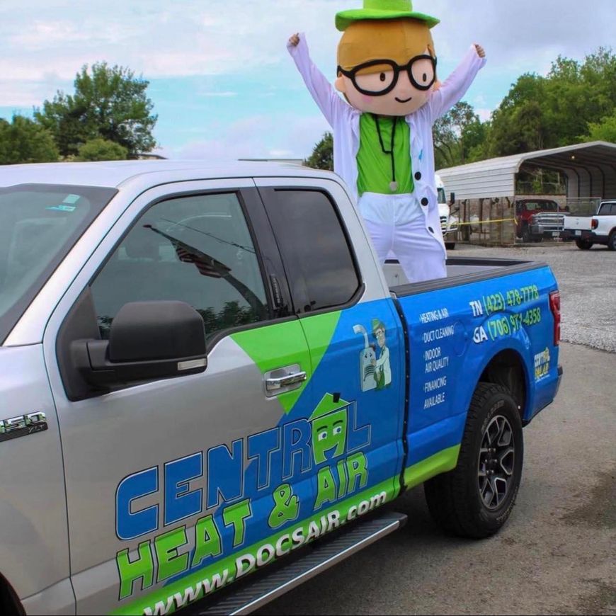 A mascot is sitting on the back of a central heat and air truck