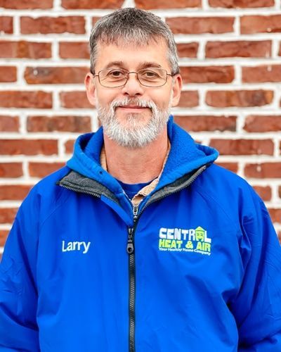 A man wearing a blue jacket that says central heat and air