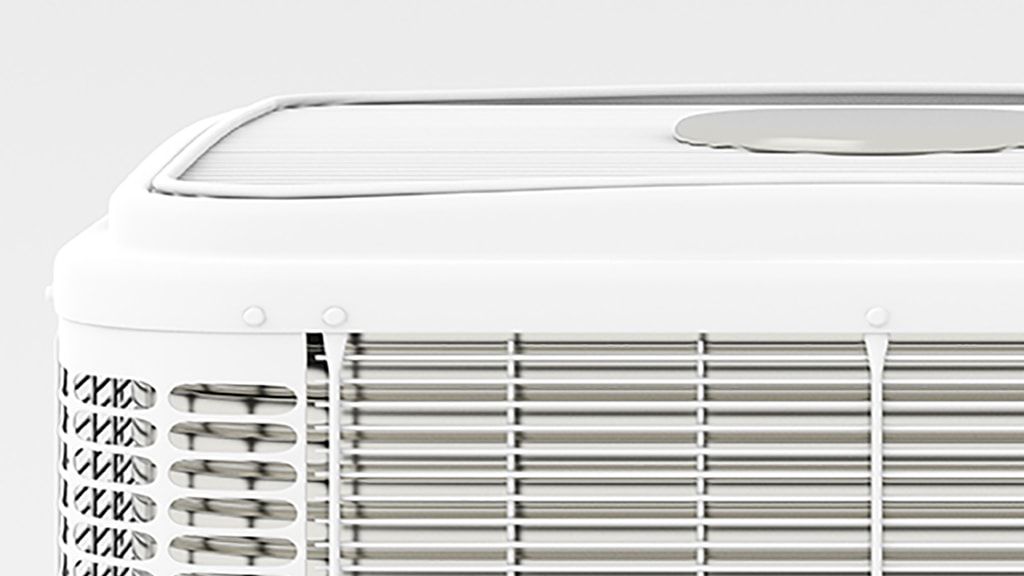 A close up of a white air conditioner on a white background.