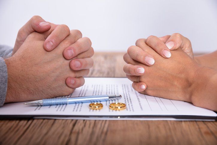 Couple's Hand with Divorce Agreement — Chesapeake, VA — Peterson Law PLC