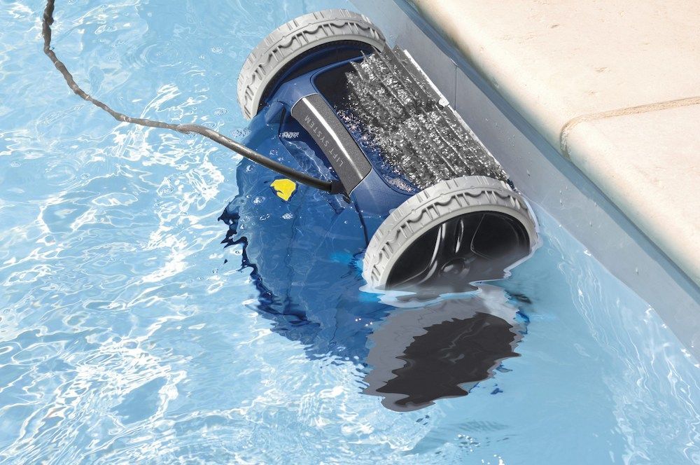 A Man Is Cleaning A Swimming Pool With A Broom — Dazzling Blue Pool & Spa Centre Gold Coast in Tweed Heads, NSW