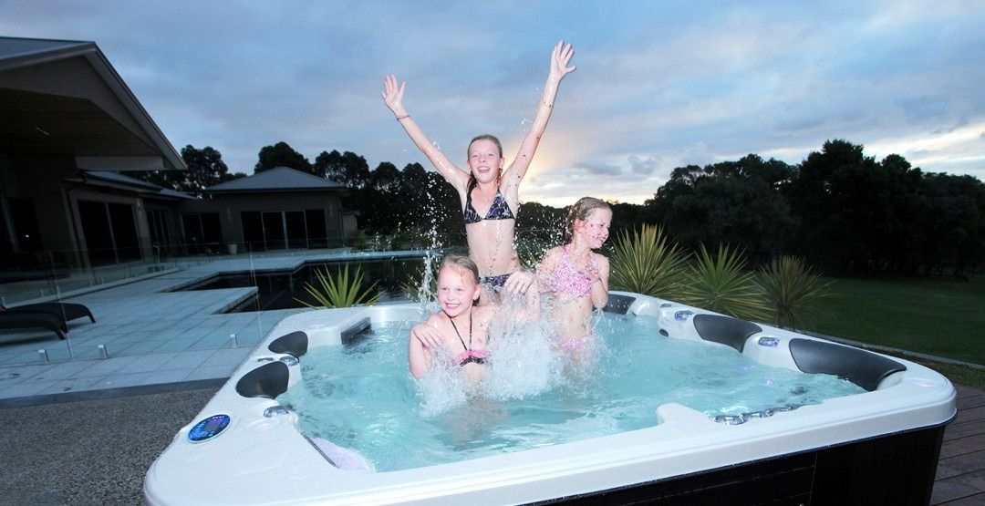 Three Young Girls Are Playing In A Hot Tub — Dazzling Blue Pool & Spa Centre Gold Coast in Burleigh Heads, QLD