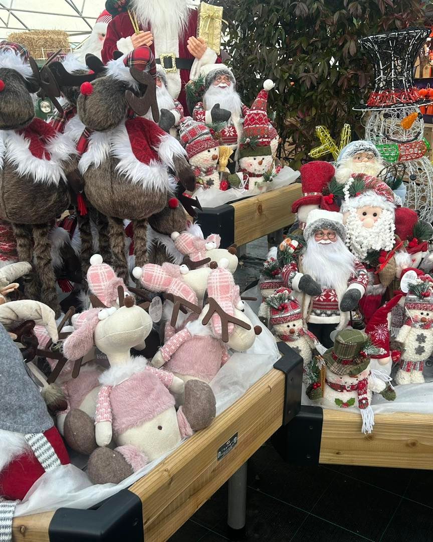 Holiday display featuring reindeer, Santas, and snowmen figures.