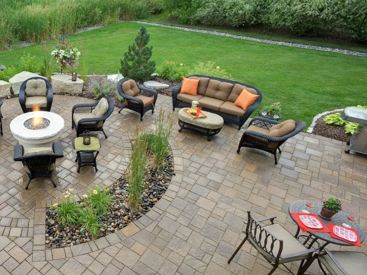 An aerial view of a patio with furniture and a fire pit.