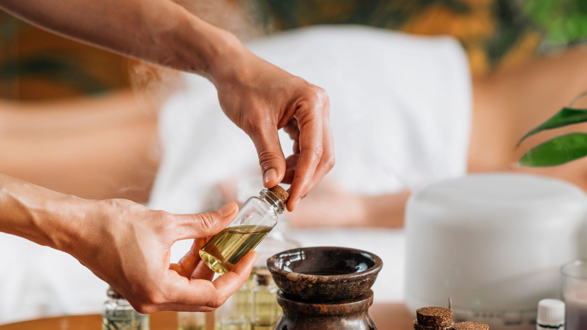 A woman is getting an ear wax treatment at a spa.