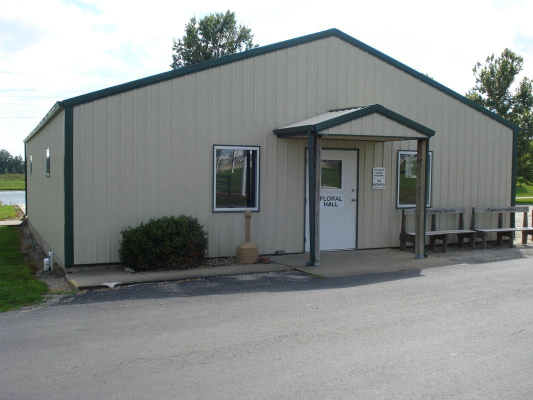 A large building with a white door and green trim