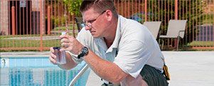 Swimming Pools Service & Repair — Man Testing the Pool Water  in Gainesville, FL
