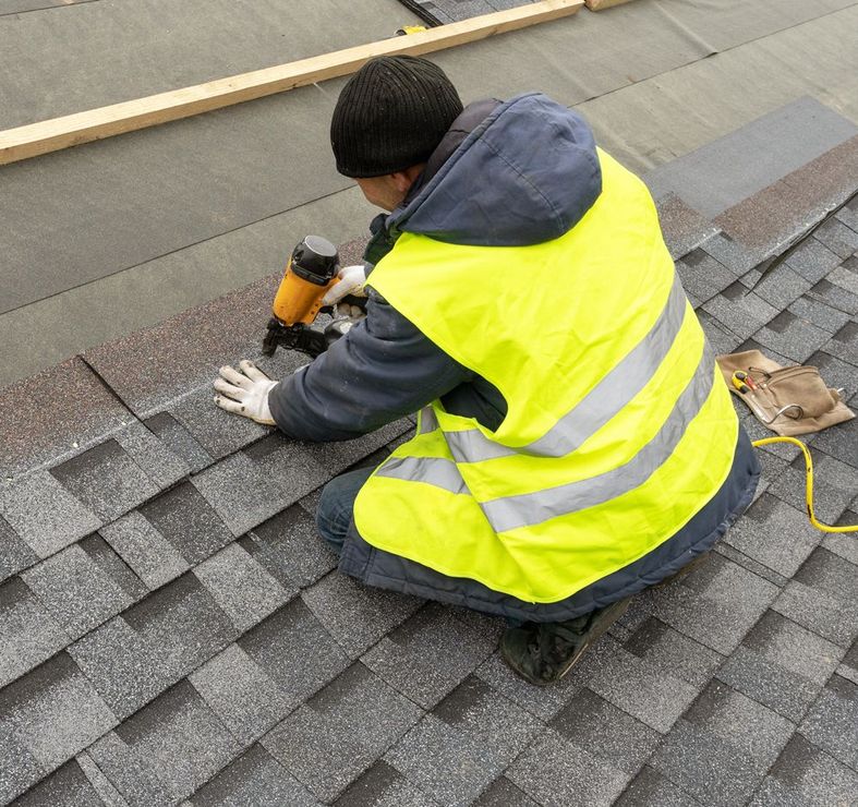 Professional Roof Worker Installing New Shingle Roof Tiles