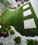 An aerial view of a lush green lawn with white stepping stones.