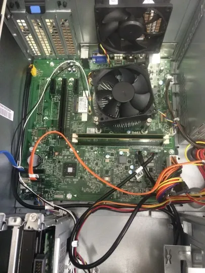 The inside of a computer with a motherboard and two fans.