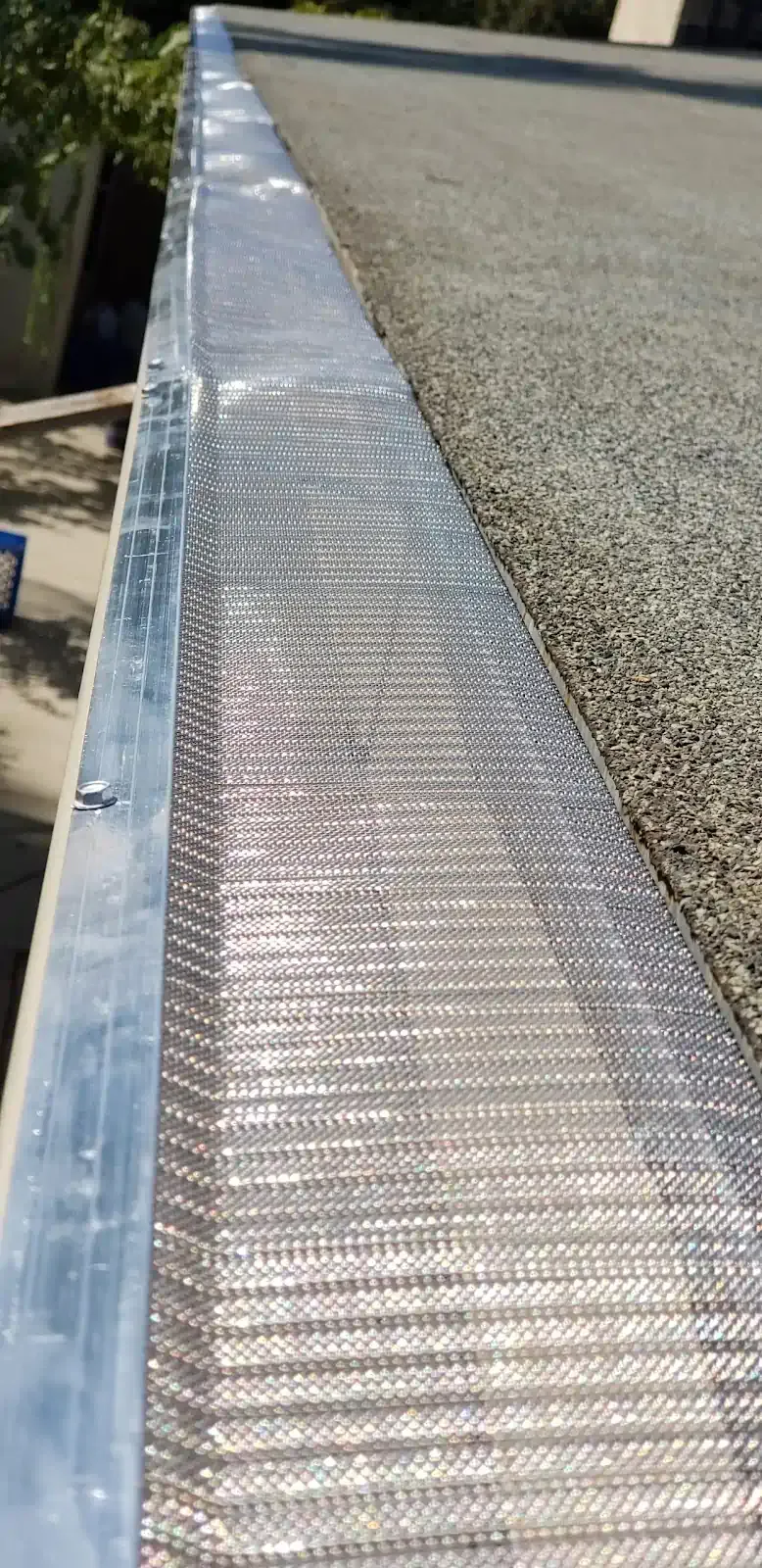 A close up of a metal gutter on a roof.
