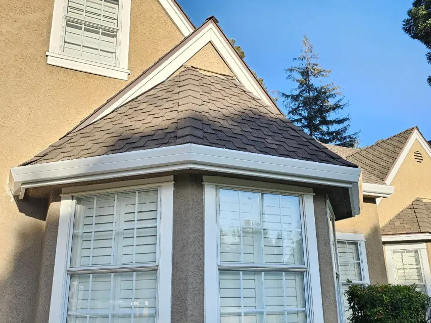 A house with a bay window and shutters on the windows