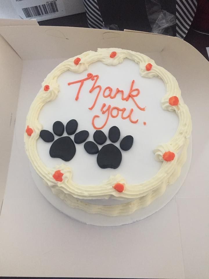 A cake that says thank you with paw prints on it