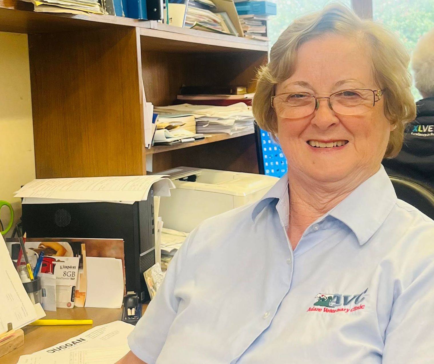 A woman wearing glasses and a shirt that says hive