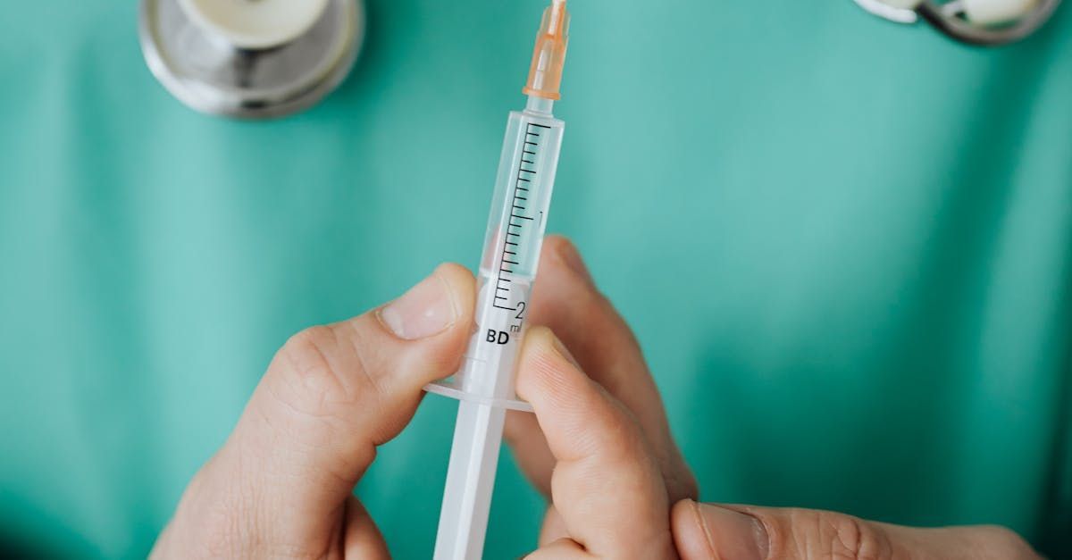 A person is holding a syringe in their hands.