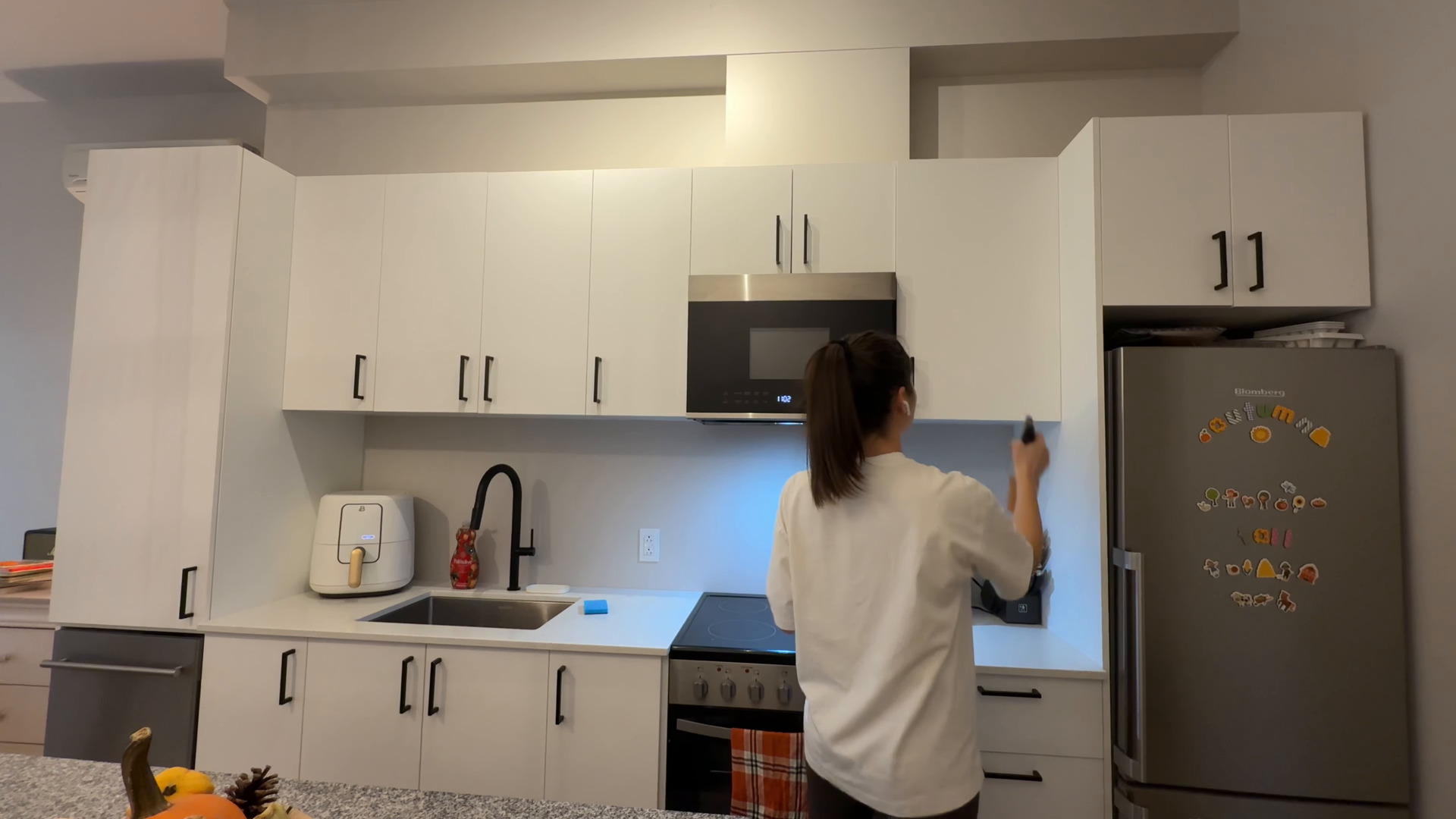 Cleaning supplies on a kitchen counter near a sink and window.