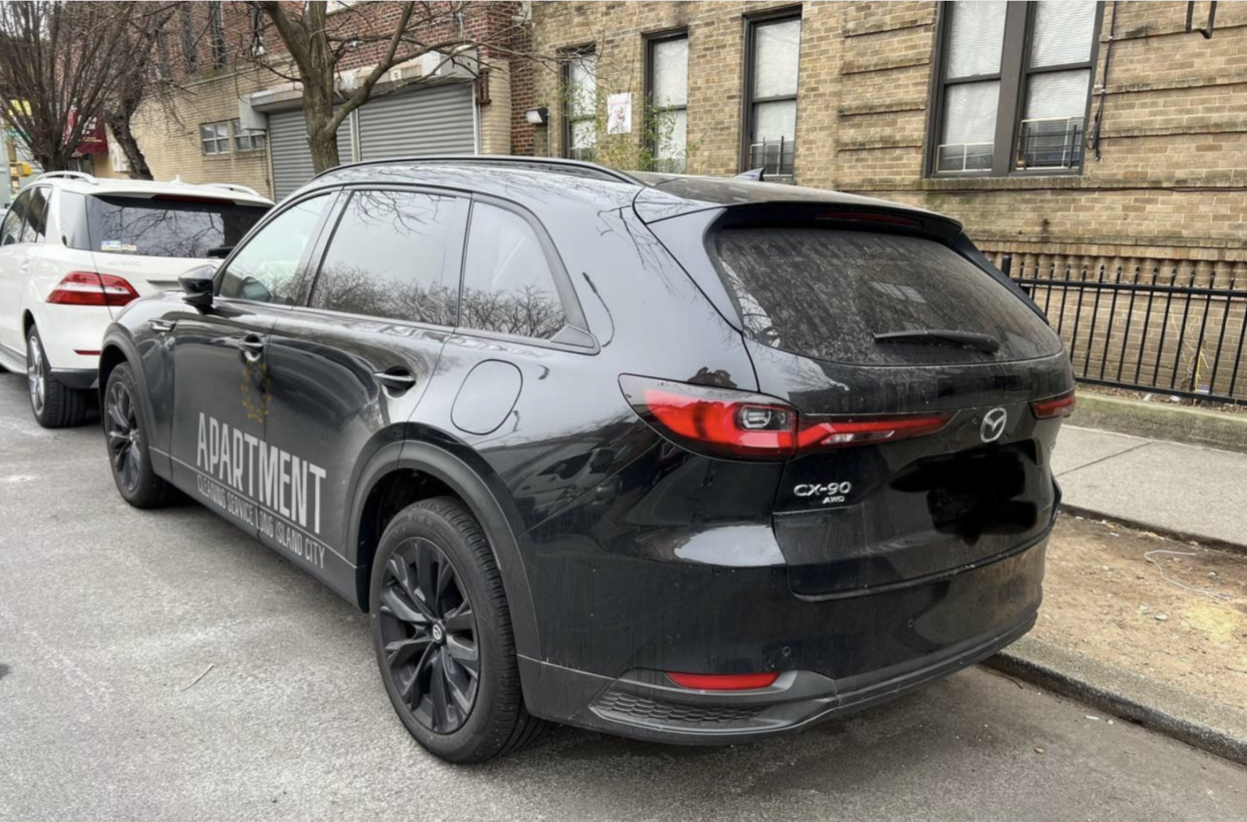 Person washing hands under running water in a white sink; soap dispenser on the side.