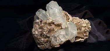 Un primo piano di un cristallo su una superficie nera.