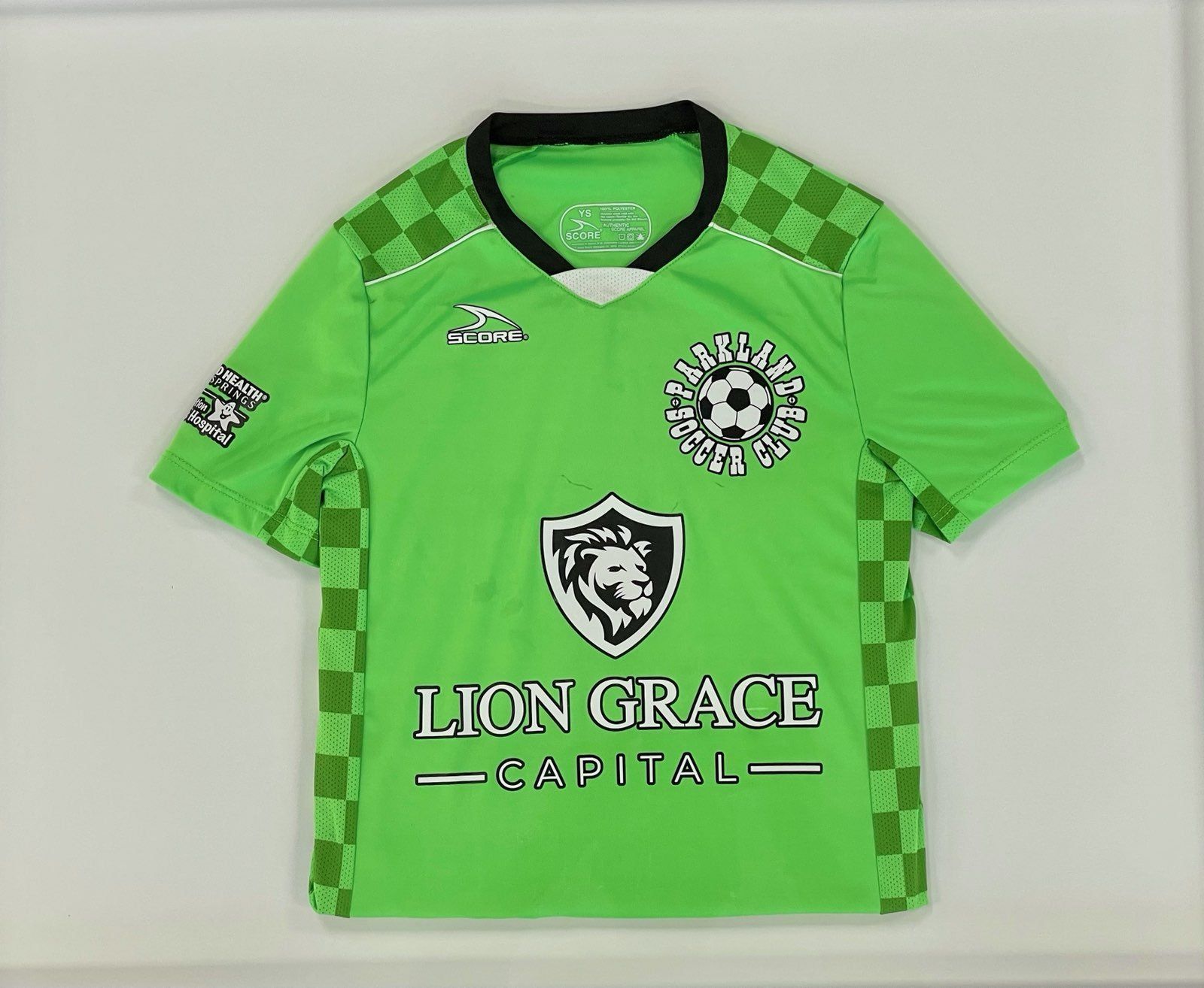 A green soccer jersey with lion grace capital written on it