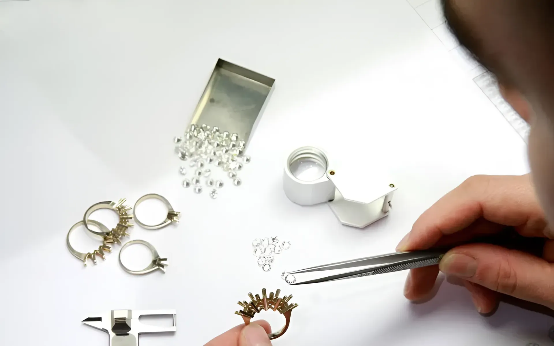 A Person is Working on a Ring With Tweezers and a Magnifying Glass — K. Smith & Son Jewellers In Caloundra, QLD