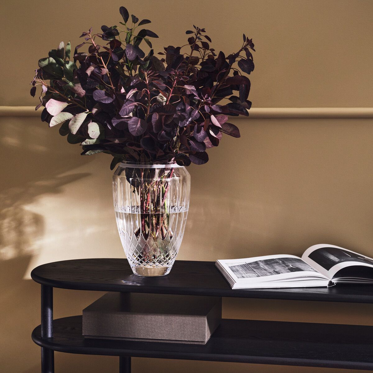 A Woman is Looking at a Ring Through a Magnifying Glass — K. Smith & Son Jewellers In Caloundra, QLD