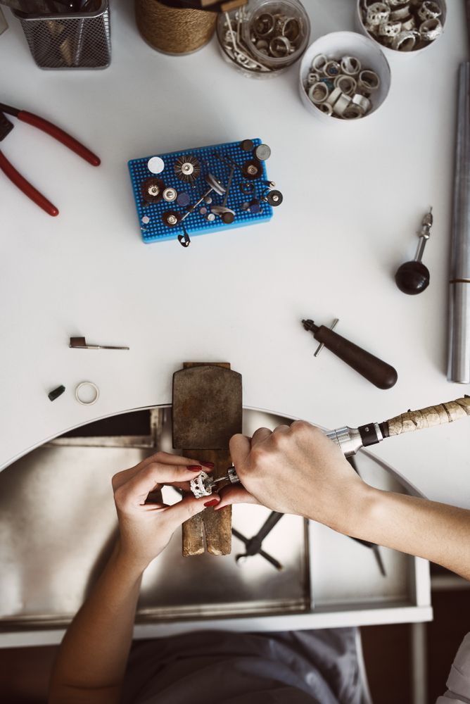 A Person is Working on a Ring at a Table — K. Smith & Son Jewellers In Caloundra, QLD